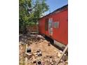 Exterior of distressed mobile home showing the side of the property with disrepair and neglect at 1416 E Southern Ave, Apache Junction, AZ 85119