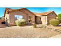 View of the property featuring a xeriscaped front yard and small patio seating with desert landscaping at 1492 E Westchester Dr, Chandler, AZ 85249