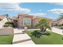 Attractive single-story home showcasing desert landscaping and an inviting walkway at 16165 W Vale Dr, Goodyear, AZ 85395