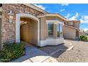 Inviting front entrance with stone accents and an outdoor hanging light fixture at 1669 E Santa Fiore St, San Tan Valley, AZ 85140