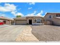 Beautiful single-story home with stone details, concrete driveway, and manicured gravel front yard at 1669 E Santa Fiore St, San Tan Valley, AZ 85140