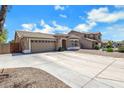Well maintained single-story home with a two-car garage and a concrete driveway at 1669 E Santa Fiore St, San Tan Valley, AZ 85140