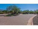 Paver entrance into the community with landscaped median and decorative stone gate at 19947 N 94Th Way, Scottsdale, AZ 85255