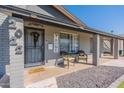 Close-up of front porch with inviting decor, chairs, and a view of the front yard at 2022 W Aster Dr, Phoenix, AZ 85029