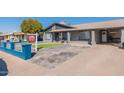 Charming single-story home featuring a covered porch and well-maintained front yard at 2022 W Aster Dr, Phoenix, AZ 85029
