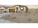 Charming one-story home features neutral tones, low-maintenance landscaping and a two-car garage at 24066 W Cocopah St, Buckeye, AZ 85326