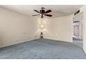 Light-filled bedroom with blue carpet, ceiling fan, and a soft, homey ambiance perfect for relaxation at 2442 N 22Nd Ave, Phoenix, AZ 85009