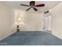 Bright bedroom features a ceiling fan, soft blue carpeting, and a welcoming atmosphere for restful nights at 2442 N 22Nd Ave, Phoenix, AZ 85009