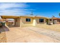 View of the house exterior and driveway featuring low maintenance gravel yard at 2802 W Butler Dr, Phoenix, AZ 85051