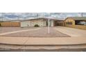 Single story home featuring low maintenance desert landscaping and a large, covered carport at 316 N Ironwood --, Mesa, AZ 85201