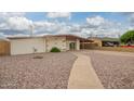 Single story home with desert landscaping, covered carport, and mature plantings at 316 N Ironwood --, Mesa, AZ 85201