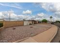 Front yard featuring easy care rock landscaping, mature trees, and a block wall at 316 N Ironwood --, Mesa, AZ 85201