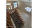 Spacious foyer with staircase, tile flooring, and natural light creating a welcoming entrance at 33512 N 24Th Ln, Phoenix, AZ 85085