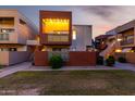 Condo building showcasing a modern design with well-lit balconies and landscaped grounds at 3500 N Hayden Rd # 710, Scottsdale, AZ 85251