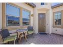 Relaxing front porch with table and chairs, perfect for enjoying the outdoors at 35486 N Morello Dr, Queen Creek, AZ 85140