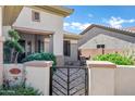 Welcoming front entryway with a stylish gate and a cozy seating area at 41215 N Lytham Ct, Phoenix, AZ 85086
