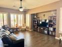 Bright living room boasts a ceiling fan, recessed lighting and plantation shutters at 41215 N Lytham Ct, Phoenix, AZ 85086