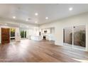 Spacious living room featuring hardwood floors, recessed lighting, and access to a courtyard and back yard at 4525 N 66Th St # 95, Scottsdale, AZ 85251