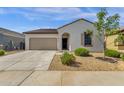A charming home boasting a two-car garage, desert landscaping, and a well-maintained lawn at 4595 W Foldwing Dr, San Tan Valley, AZ 85144