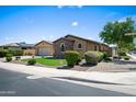 Well-kept home with beautiful desert landscaping and a two-car garage, highlighting attractive curb appeal in the neighborhood at 4721 N Aldea W Rd, Litchfield Park, AZ 85340
