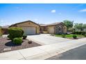 Lovely home featuring desert landscaping, an extended driveway, and a two-car garage, displaying a well-maintained exterior at 4721 N Aldea W Rd, Litchfield Park, AZ 85340