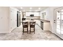 Bright kitchen featuring white cabinets, stainless steel appliances and a spacious center island at 4838 W Christine Cir, Glendale, AZ 85308