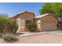 Attractive single-story residence showcasing a tidy yard and a practical two-car garage at 5439 W Sands Rd, Glendale, AZ 85301
