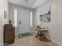 Comfortable foyer showing neutral walls, tiled floors, and decorative furniture at 6213 W Gambit Trl, Phoenix, AZ 85083