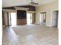 Spacious living room featuring a ceiling fan, built-in shelving, and sliding glass doors at 6436 W Saddlehorn Rd, Phoenix, AZ 85083