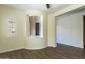 Inviting living room showcasing a large window, decorative niche, and wood-look tile flooring at 70 E Kennedia Dr, Queen Creek, AZ 85140