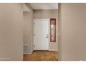 Welcoming entryway with tile flooring, a solid wood door, and decorative window covering, bathed in neutral tones at 7101 W Beardsley Rd # 1502, Glendale, AZ 85308