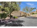 Charming townhome featuring a private two-car garage and lush landscaping with mature trees at 7101 W Beardsley Rd # 1502, Glendale, AZ 85308