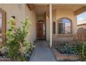 Inviting front entrance with a solid wood door and desert landscaping with decorative brick border at 725 W Beth Dr, Phoenix, AZ 85041