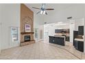 Open-concept living room with fireplace flowing into the kitchen with high ceilings at 725 W Beth Dr, Phoenix, AZ 85041