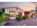Inviting front yard with desert landscaping and colorful plants accentuating the facade of this home at 816 W Sycamore Ct, Litchfield Park, AZ 85340