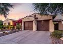 Spacious three-car garage with dark wood doors and a paved driveway, enhancing the home's curb appeal at 816 W Sycamore Ct, Litchfield Park, AZ 85340