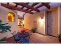 Cozy covered patio with comfortable seating, offering a relaxing outdoor space with pergola and tiled flooring at 816 W Sycamore Ct, Litchfield Park, AZ 85340