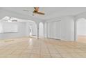 Spacious living area with tile flooring, ceiling fan, and archways into other rooms at 962 W Keating Ave, Mesa, AZ 85210