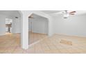 Bright and spacious living room featuring neutral tile flooring and a ceiling fan at 962 W Keating Ave, Mesa, AZ 85210