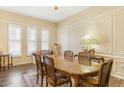 Formal dining room featuring natural light, wood-look tile flooring, and classic decor at 10619 W Loma Blanca Dr, Sun City, AZ 85351