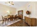 Elegant dining room with decorative molding, chandelier, and wood-look tile flooring at 10619 W Loma Blanca Dr, Sun City, AZ 85351