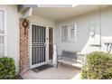 Cozy front entry featuring a decorative security door, bench, and exterior lighting at 10619 W Loma Blanca Dr, Sun City, AZ 85351