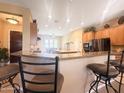 Open-concept kitchen with bar stool seating at the granite countertop island, perfect for entertaining and casual dining at 12826 W La Vina Dr, Sun City West, AZ 85375