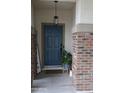 The front door has brick accents, a stylish light fixture, and a potted plant at 14977 W Charter Oak Rd, Surprise, AZ 85379