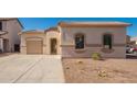 Inviting single-story house with dual garages and desert landscaping on a sunny day at 15518 W Ocotillo Ln, Surprise, AZ 85374