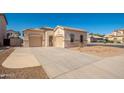 Attractive single-story house with dual garages, desert landscaping, and spacious driveway at 15518 W Ocotillo Ln, Surprise, AZ 85374
