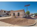 Well-kept corner lot home with desert landscaping, a tile roof, and a charming front facade at 15518 W Ocotillo Ln, Surprise, AZ 85374