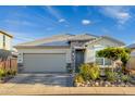 Attractive single-story home with a two-car garage and well-maintained landscaping at 16551 W Winston Dr, Goodyear, AZ 85338