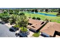 Stunning aerial view of a home near a golf course and water feature, showcasing its prime location and community at 18626 N 130Th Ave, Sun City West, AZ 85375