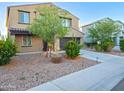 Well-manicured front yard with desert landscaping and a long driveway at 19954 W Moonlight Path, Buckeye, AZ 85326